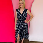 Navy polka dot midi dress with front zipper and elastic waist.