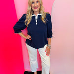 Navy puff sleeve top with scalloped trim and contrast neckline