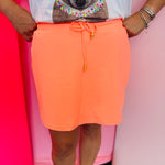 Solid skort with elastic back waistband, drawstring, built-in shorts, and side pockets.