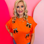 Orange ruffled side top with round neck and football chenille patches 