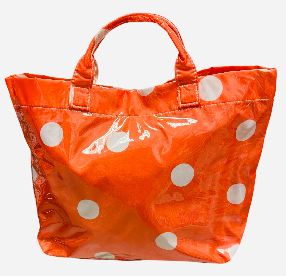 Orange polka dot tote bag with shiny finish and white dots.