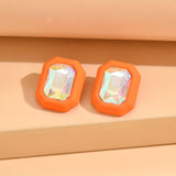 Oversized orange rhinestone stud earrings with bold sparkle.