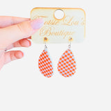 Orange and white checkered teardrop earrings in glossy acrylic, lightweight and perfect for bold style.