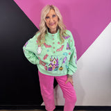 Mint Halloween pullover with colorful pumpkins, bats, candy, witch hats, sequins, and gemstone buttons.
