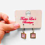 Gold-tone hoops with faceted pink square crystal drop earrings.