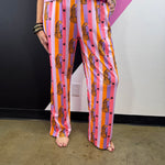 Pink orange and lavender striped pants with spotted leopards, black stars and elastic waist.