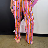 Pink orange and lavender striped pants with spotted leopards, black stars and elastic waist.