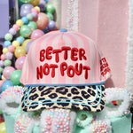 Pink striped Better Not Pout Christmas hat with leopard bill and teal trim.