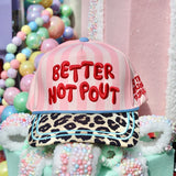 Pink striped Better Not Pout Christmas hat with leopard bill and teal trim.