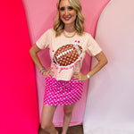 Light pink cropped tee with polka dot football and That Game Day Feeling graphic.