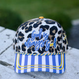 Leopard hat with God Is Always Good embroidery and blue striped bill.
