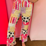 Wide leg patchwork jeans with pink prints, polka dots, stripes, and lace pockets.