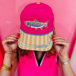 Pink faux suede hat with fish embroidery, striped bill, and Reel-y Busy detail.