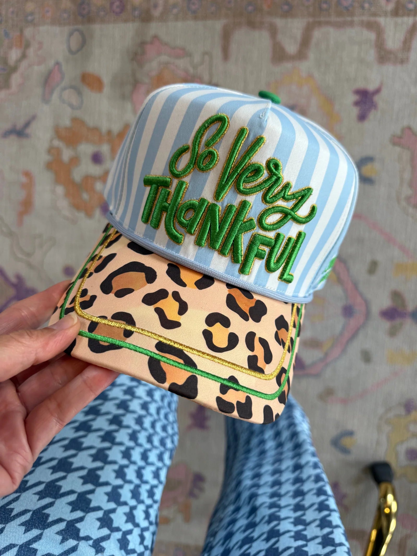 Blue striped hat with green So Very Thankful embroidery, leopard bill, and gold piping.