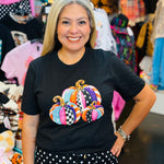Black tee with colorful pink, turquoise, orange, and purple patterned pumpkins.