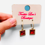 Gold-tone hoops with faceted red square crystal drop earrings.