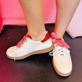 Cream sneakers with red panels and retro gingham lace detail