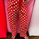 Red and white polka dot cropped barrel pants with drawstring waist and pockets.