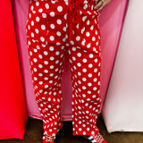 Red and white polka dot cropped barrel pants with drawstring waist and pockets.