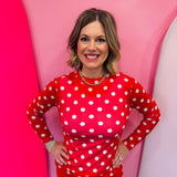 Red mesh top with white polka dots and mock neckline.