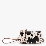 Cow print crossbody bag with multiple compartments and adjustable strap in vegan leather