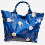 Royal blue polka dot tote bag with shiny finish and white dots.