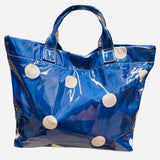 Royal blue polka dot tote bag with shiny finish and white dots.