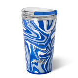 A 24oz Swig branded insulated party cup with a geometric pattern of blue and white swirls and a blue lid with a slider opening.