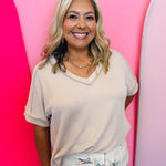 Sand beige corded rib knit top with hi-low V-neck and short sleeves