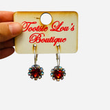 Silver hoop earrings with red gemstone drop and rhinestone halo