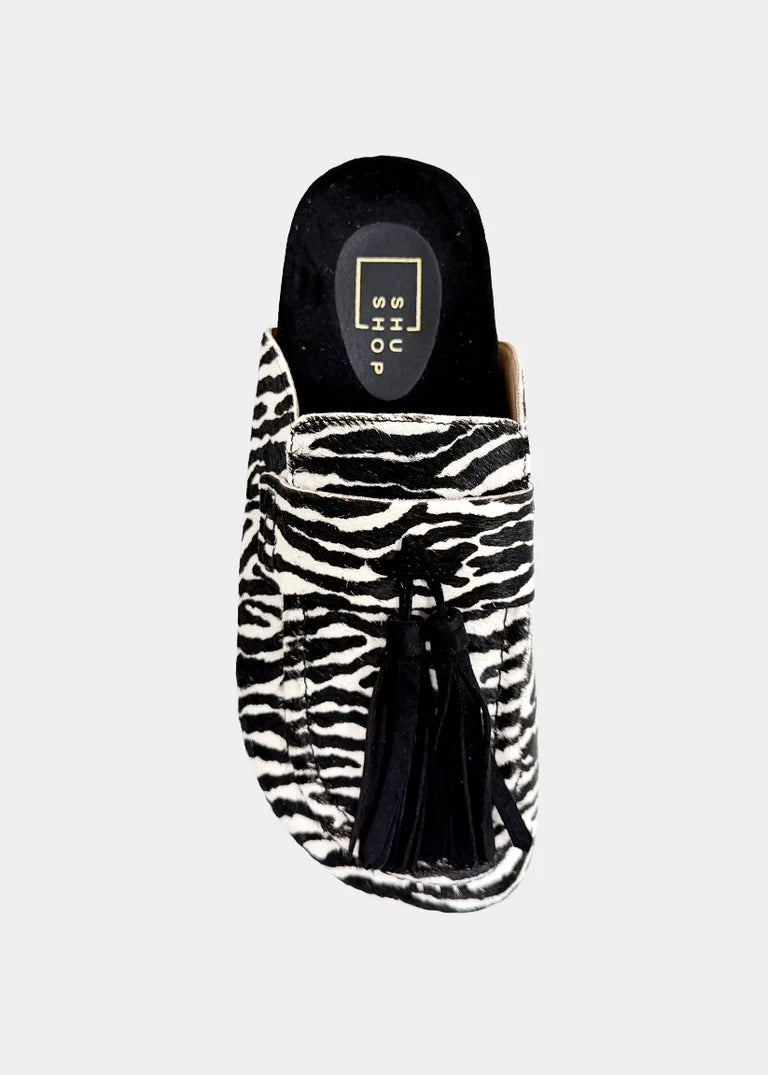 Shu Shop Ariana zebra print hair-on mule with black fringe and adjustable buckle.