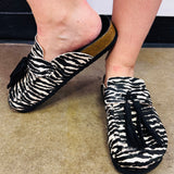 Shu Shop Ariana zebra print hair-on mule with black fringe and adjustable buckle.