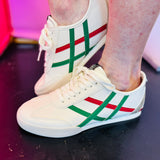 White sneaker with red and green stripes and gold heel accent