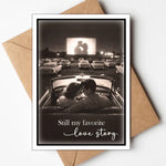 Romantic card with vintage drive-in movie scene and couple in convertible.
