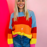 Oversized striped crochet sweater with distressed edges, relaxed boho style layering top.