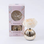 Sweet Grace holiday flower diffuser with pink blooming flower and metallic vase.