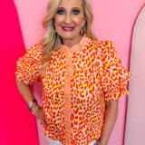 Tangerine leopard print puff sleeve top with ruffle collar and button front
