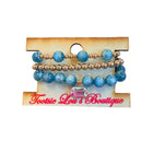 Teal blue beaded stretch bracelet set with gold accents and crystal charm.