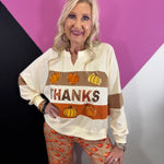 Fall pullover with embroidered pumpkins and shimmering sequin accents.