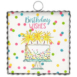 Metal birthday decor sign with scalloped edge, cake illustration, and colorful confetti dots.
