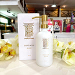 Thomas Blonde Blonde hand soap in white glass bottle with gold pump.
