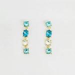 Teal and turquoise crystal drop earrings with cascading faceted stones and elegant dangle design.