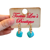 Gold beaded hoop earrings with glossy turquoise resin cube accents.