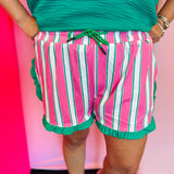 Pink and white striped shorts with green trim and ruffle detail elastic waistband