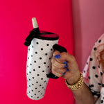 White 40oz tumbler with black polka dots, flip straw lid, and handle.