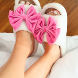 White and pink cozy bow open-toe house slippers.