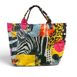 Colorful mixed-print tote bag with zebra, leopard, and polka dot designs.