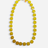 Yellow opaque crystal tennis necklace with gold-tone settings and magnetic clasp.