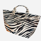 Zebra print PVC tote bag with large capacity and structured design, black and white stripes