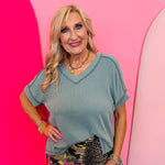 Jade green corded rib knit top with hi-low V-neck and short sleeves